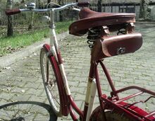 Details der Ausstattung: Werkzeugtasche mit nur einem Verschluss; Luftpumpe aus Metall, weiß lackiert; Lenkergriffe aus Duroplast. Das strahleförmige Kleidernetz ist vrmtl. nicht original.