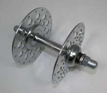 RENAK-Hochflanschnabe für Radballfahrräder Zeitraum: 196x bis 198x Verwendung: Mifa Radballräder Material: Stahl (verchromt) Befestigung: Hutmuttern (FG 9,5) Bemerkungen: große Flansche zum Bau besonders steifer Laufräder